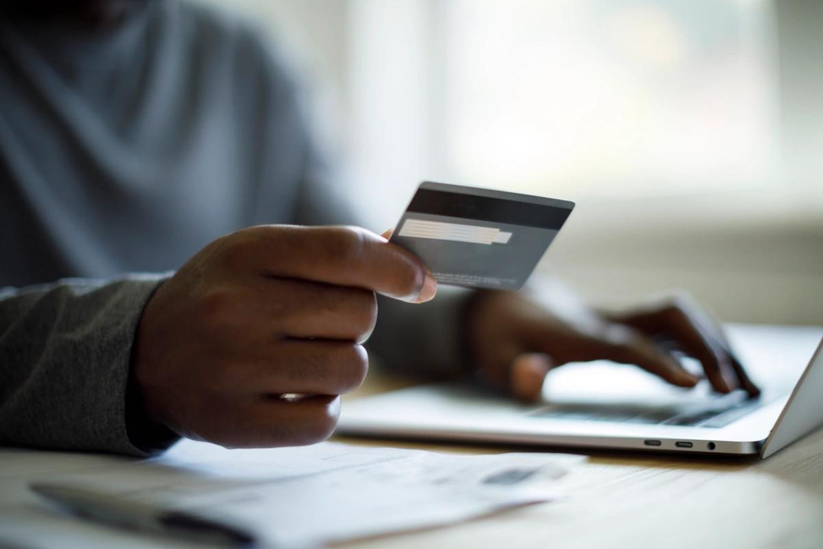 Image of a man looking at a credit card. How neurodiversity can affect the way you are with money