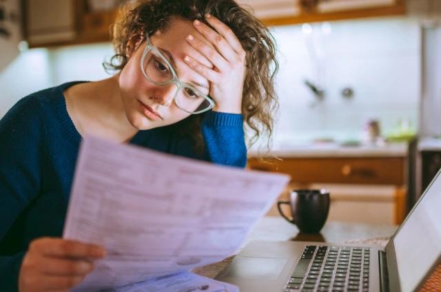 Stressed woman looking at bills