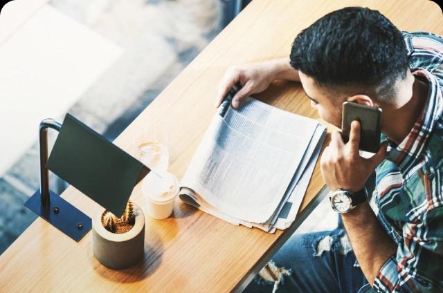 Man on phone looking at papers