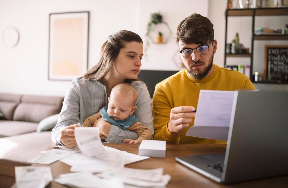 Couple with baby sorting their finances