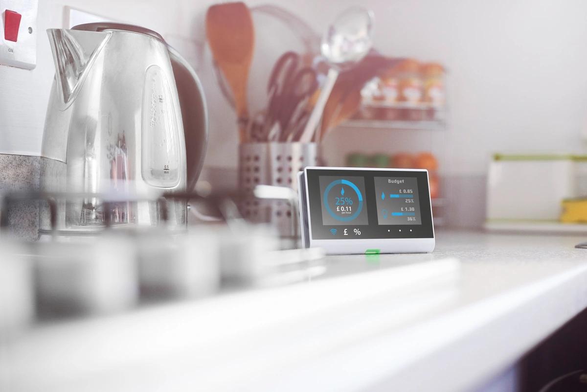 A stock image of a smart meter next to a kettle and hob.