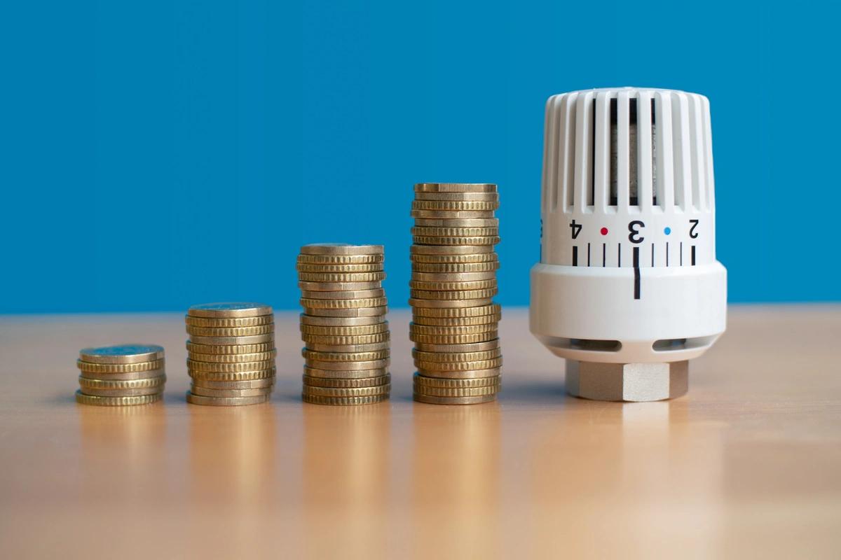 Rows of pound coins next to a radiator dial