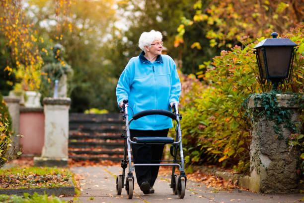 Image of a pensioner walking with a frame. Labour confirms commitment to the triple lock. Find out what the triple lock is