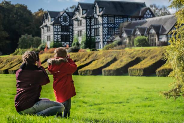 Image of a family outside a National Trust property. Free National Trust summer family passes