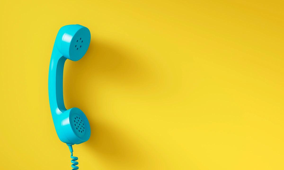 Illustration of blue telephone against yellow background