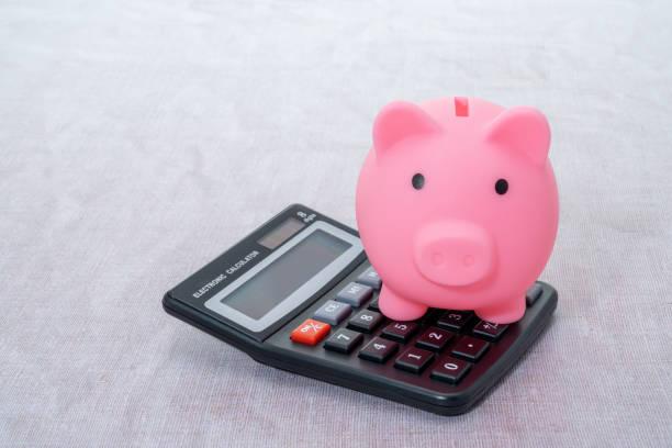 Illustrated image of a piggy bank sat on top of a calculator. Key money dates in June. Huge money changes in June which could impact your household finances. Changes to debt relief orders