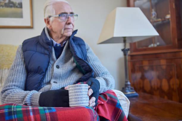 Image of an elderly man looking cold in his home. Octopus Energy launches its own 'winter fuel payments'